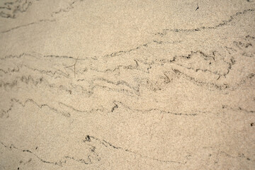 Unique patterns in soft beach sand reveal nature's artistry