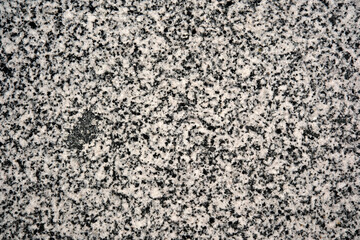 Textured granite surface adorned with specks of white minerals