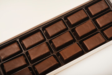 Chocolates in a box. A set of candies with white filling.