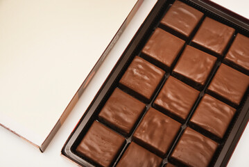 Chocolates in a box. A set of candies with white filling.