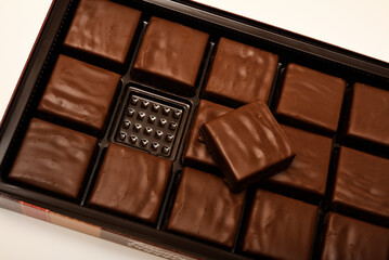 Chocolates in a box. A set of candies with white filling.