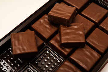 Chocolates in a box. A set of candies with white filling.