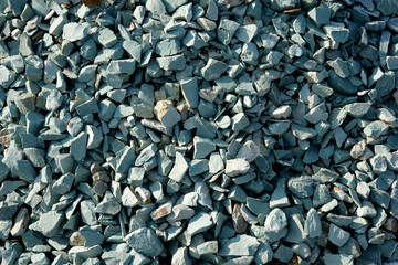 Textured green gravel scattered across an outdoor workspace