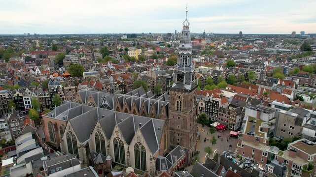 Stunning aerial shot of Oude Kerk Amsterdam showcasing its iconic canals, historic architecture, and vibrant cityscape. 