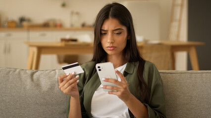 Serious Indian woman Arabian girl female try pay online confused difficulty payment transaction...