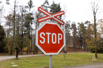 The sign of a stop at a railway crossing. A red mark on a railway station