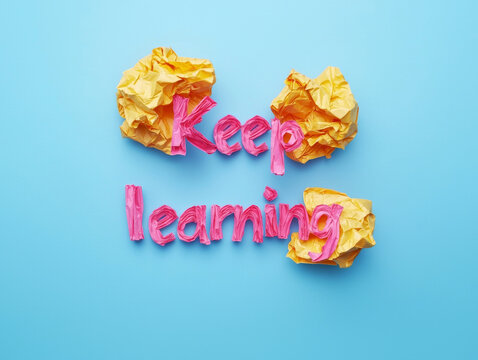 Keep Learning: Pink and yellow crumpled paper letters -ai