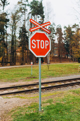 The sign of a stop at a railway crossing. A red mark on a railway station