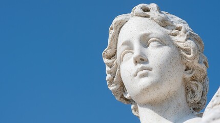 Obraz premium Angel Statue Head Against Blue Sky; Art; Sculpture; Outdoor; Possible use for prints or digital media