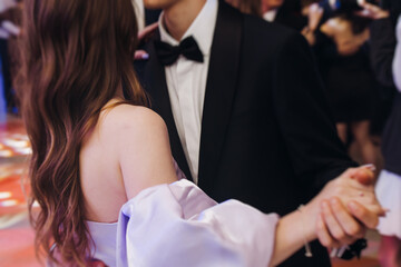High school graduates dancing on prom, waltz and classical ball slow dance in dresses and suits on...