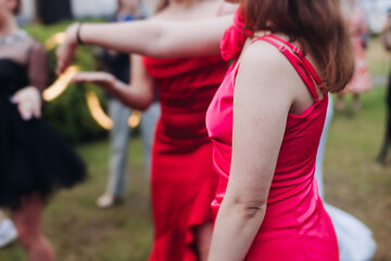 High school graduates dancing on prom, waltz and classical ball slow dance in dresses and suits on...