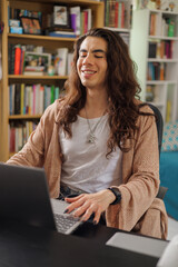 Non-binary person wearing glasses working from home