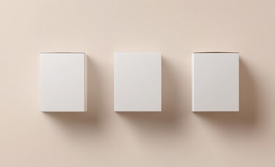 Naklejka premium Three blank white boxes on a beige background.