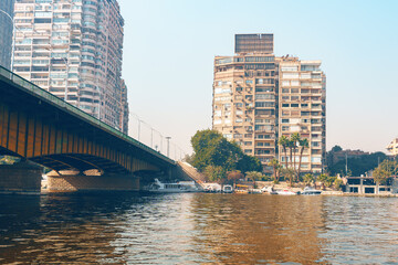 Cityscape view of Cairo with a bridge crossing the Nile River under the sunlight