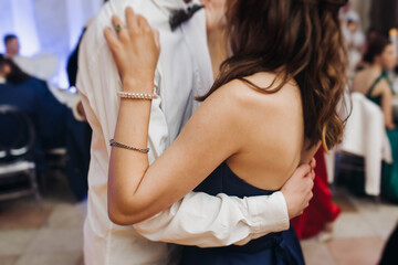 High school graduates dancing on prom, waltz and classical ball slow dance in dresses and suits on...