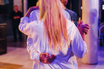 High school graduates dancing on prom, waltz and classical ball slow dance in dresses and suits on...