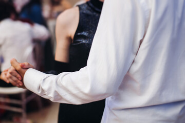 High school graduates dancing on prom, waltz and classical ball slow dance in dresses and suits on...