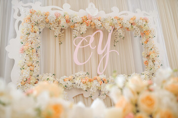 Wedding photo backdrop with floral frame and initials