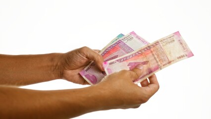 Hands holding and counting indian rupee bills over an isolated white background