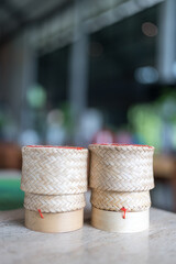 Thai sticky rice in a woven bamboo basket. Wooden bamboo traditional style box