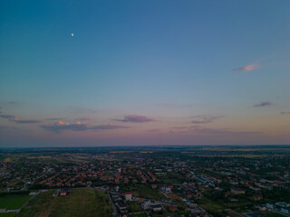 Residential neighborhood seen from above. Lots of houses in a field at sunset. Human settlements on the outskirts of the city 4k