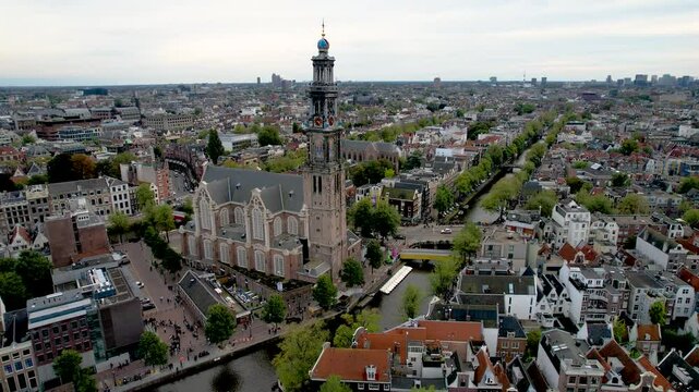 Stunning aerial footage of Westerkerk, the Protestant church in Amsterdam showcasing its iconic architecture, and vibrant cityscape.