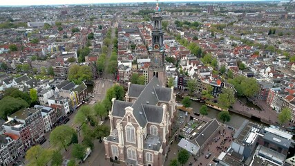 Stunning aerial footage of Westerkerk, the Protestant church in Amsterdam showcasing its iconic architecture, and vibrant cityscape.