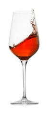 Rose wine splashing in glass on white background