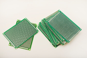 A green breadboard for electronics. The printed circuit board.