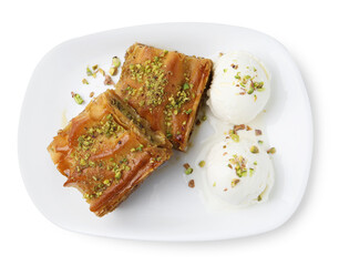 Delicious baklava with crushed nuts and ice cream isolated on white, top view