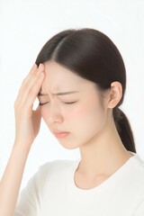 Young Woman Touching Her Temples with a Tense Expression