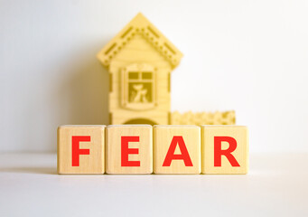 Fear symbol. Concept word Fear on beautiful wooden blocks. Beautiful white table white background. Wooden beautiful house. Business, lifestyle and fear concept. Copy space.