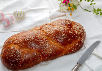 Easter sweet bread, homemade tsoureki braid on white table cloth