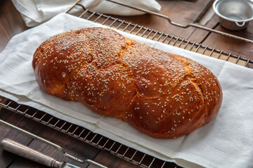 Fresh baked tsoureki braid. Easter sweet bread on the table, blur kitchen background