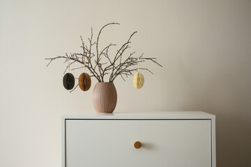 Chic minimalist easter decor features dry branches with craft eggs elegantly arranged in a simple...