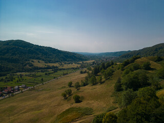 Naklejka premium Picturesque landscape with high hills and forests at the foot of the Carpathian Mountains in sunny weather in summer season