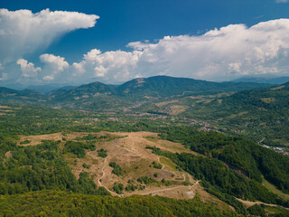 Fototapeta premium Picturesque landscape with high hills and forests at the foot of the Carpathian Mountains in sunny weather in summer season
