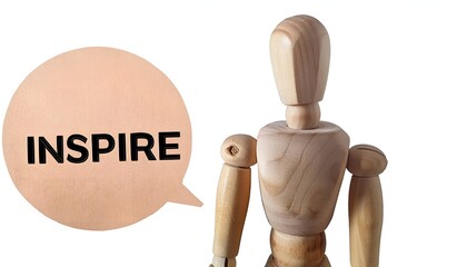 Wooden mannequin with the word Inspire isolated on white background. Perfect for motivation, creativity, and inspirational themes.