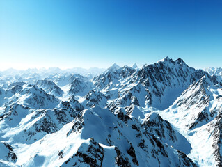 Naklejka premium A breathtaking view of snow-capped mountains under a clear blue sky, creating a serene winter landscape