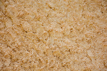 Texture of a Natural Sandy Surface With Subtle Variation in Color and Depth in Daylight