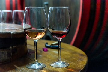 Wine tasting in the wine cellar. Wine degustation in old wine cellar with wine barrels