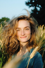 Embrace the Beauty of Nature: A Smiling Woman Among Wheat Fields Under the Warm Sunlight, Capturing the Essence of Joy and Serenity in the Great Outdoors