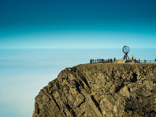 Nordkapp monument on cliff with people