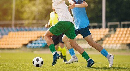 Adult Football Game Tournament. Players in Soccer Duel at the Stadium. Soccer Football Match on a League Championship. Soccer Player Dribbling and Kicking Soccer Ball Towards Goal