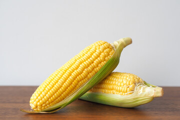 Fresh corn on wooden table background