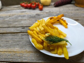 Close-up with French fries and delicious sausage . high quality photos.