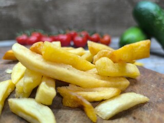 Close-up with French fries and delicious sausage . high quality photos.