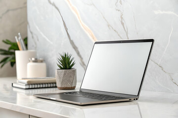 Fototapeta premium Laptop With Blank Screen On Marble Desk With Plant And Stationery Setup In