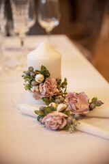 Decorative candle with a flower composition, soft pink roses and herbs
