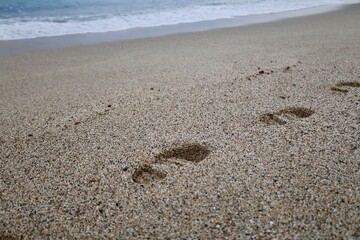 Footprints sandy beach. High quality photo